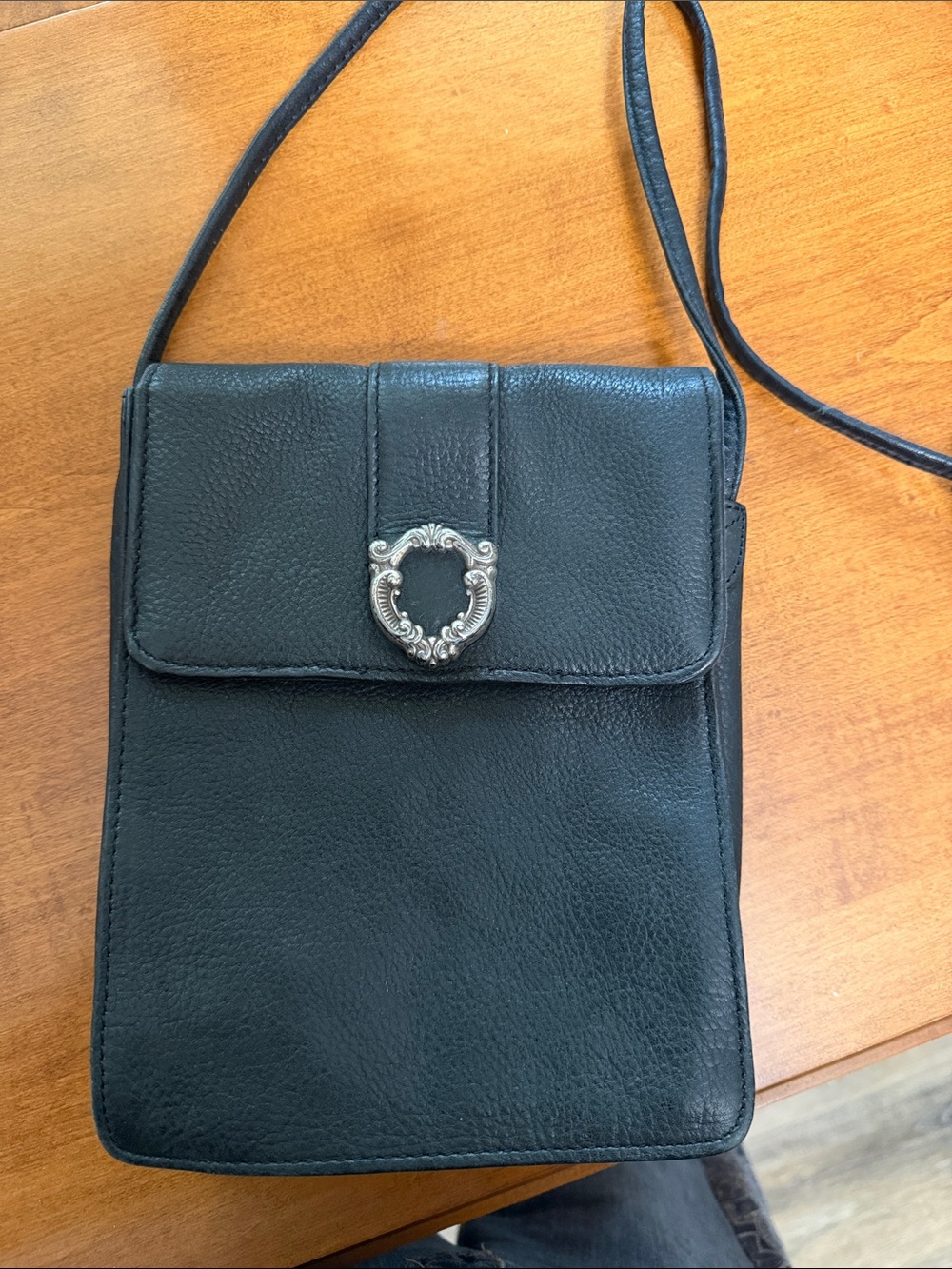 Black Leather Crossbody Bag with Decorative Silver Accent
